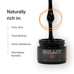 Jar of Shilajit with a black spoon inside, labeled 'Naturally rich in' with listed components.